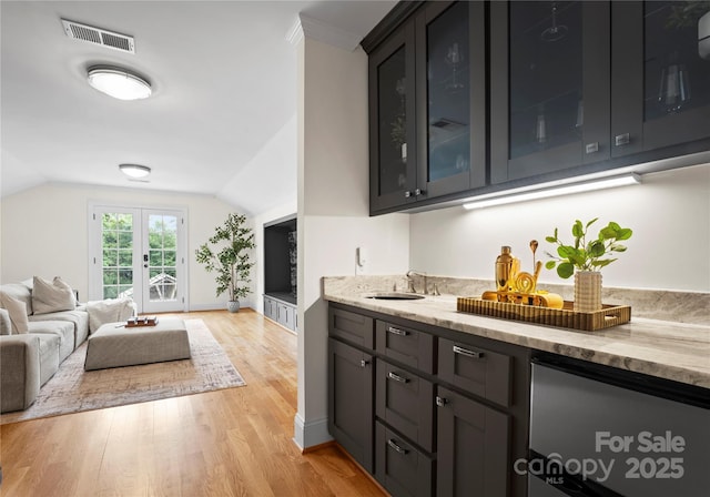 8300 Fairview Rd, Charlotte, NC 28226 - bar with a sink, light wood-type flooring, vaulted ceiling, and baseboards