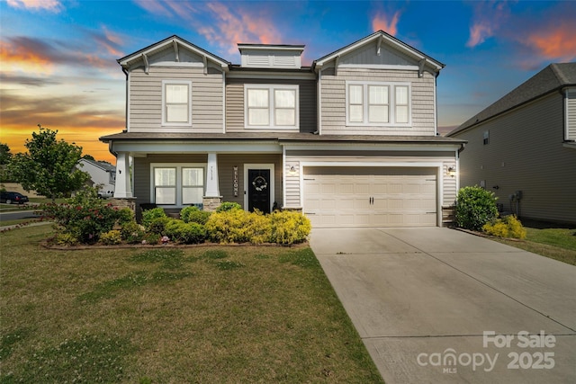 view of front facade featuring an attached garage, driveway, a front lawn, a porch, and stone siding