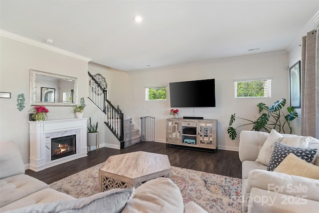 living room with stairway, ornamental molding, dark wood-style floors, baseboards, and a premium fireplace