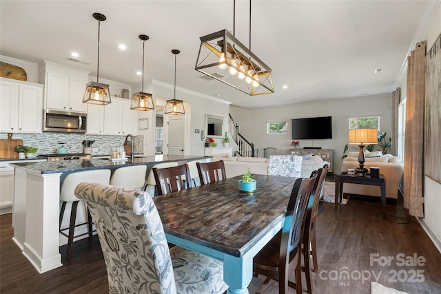 dining room featuring stairway, recessed lighting, dark wood-style flooring, and ornamental molding