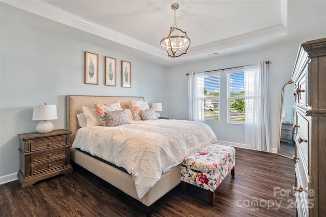 bedroom with ornamental molding, a tray ceiling, baseboards, and dark wood-type flooring