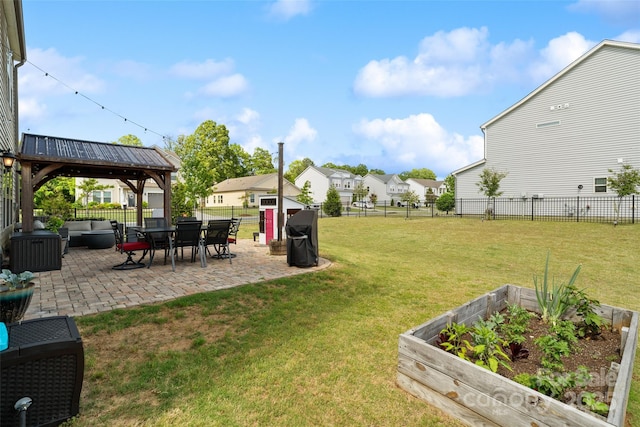 view of yard featuring a vegetable garden, a patio area, an outdoor hangout area, a gazebo, and a residential view