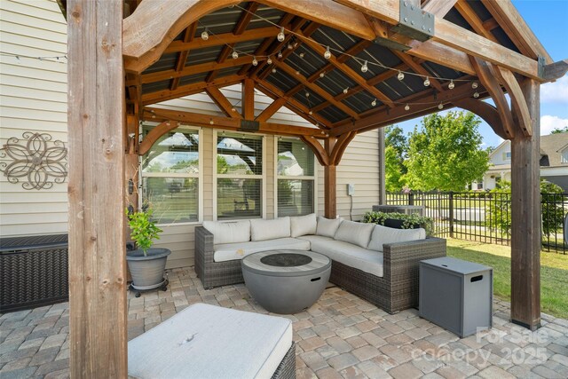 view of patio / terrace featuring an outdoor hangout area, fence, and a gazebo