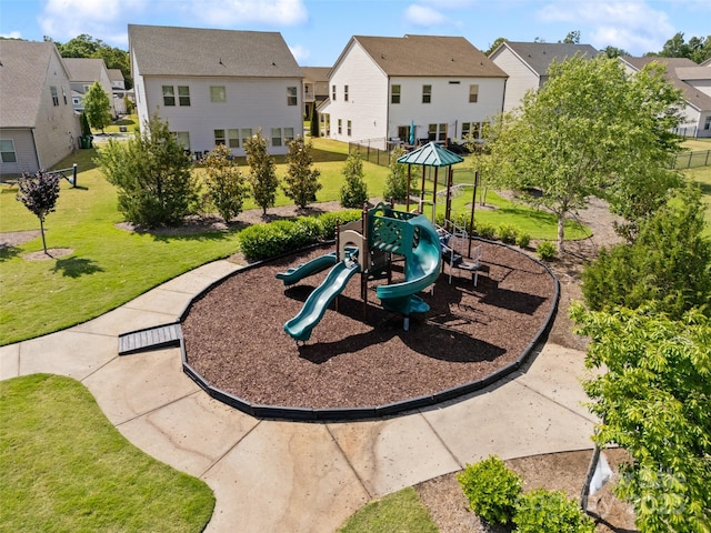view of playground with a residential view and a yard
