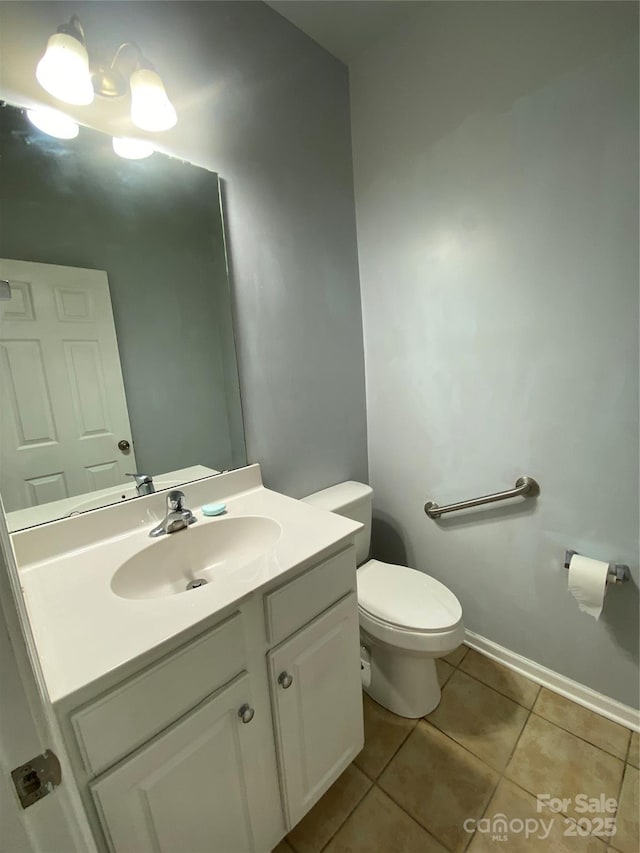 half bathroom featuring toilet, baseboards, tile patterned flooring, and vanity