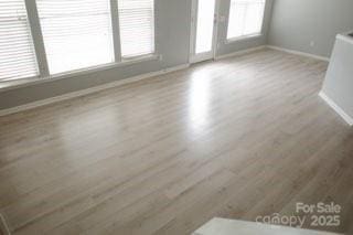 10901 Claude Freeman Dr, Charlotte, NC 28262 - unfurnished living room with baseboards and wood finished floors