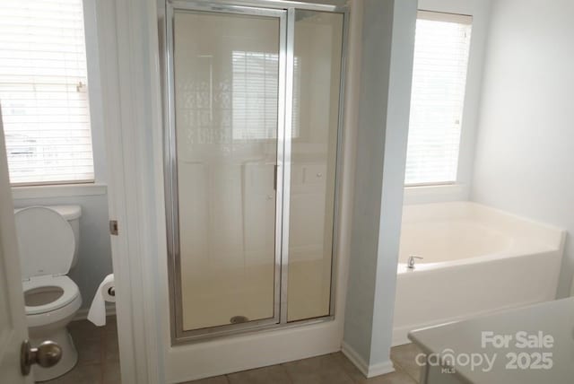 10901 Claude Freeman Dr, Charlotte, NC 28262 - bathroom with a shower stall, a bath, toilet, and tile patterned flooring
