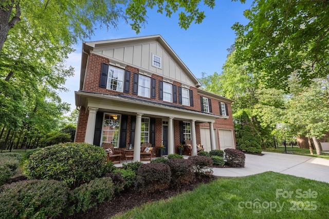 1108 Longwood Ct, Matthews, NC 28104 - view of front of property featuring brick siding, board and batten siding, driveway, covered porch, and an attached garage