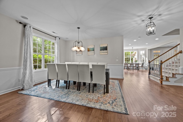 1108 Longwood Ct, Matthews, NC 28104 - dining room featuring a chandelier, stairway, hardwood / wood-style flooring, baseboards, and recessed lighting
