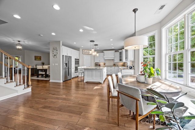 1108 Longwood Ct, Matthews, NC 28104 - dining space with dark wood-style floors, stairs, recessed lighting, and baseboards