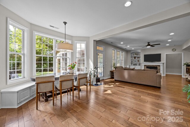 1108 Longwood Ct, Matthews, NC 28104 - living room featuring light wood finished floors, a ceiling fan, a fireplace, recessed lighting, and baseboards