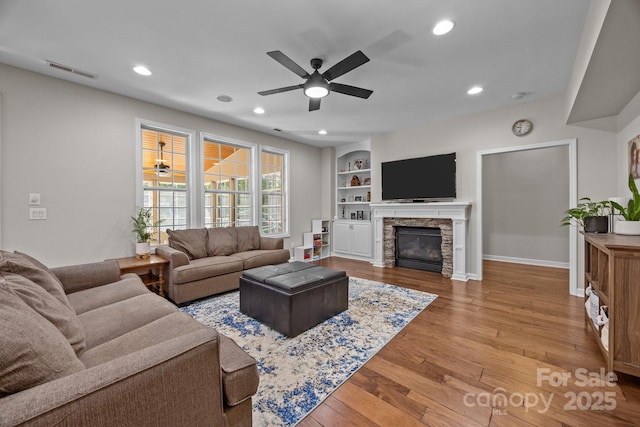 1108 Longwood Ct, Matthews, NC 28104 - living room featuring a ceiling fan, wood finished floors, recessed lighting, a fireplace, and baseboards