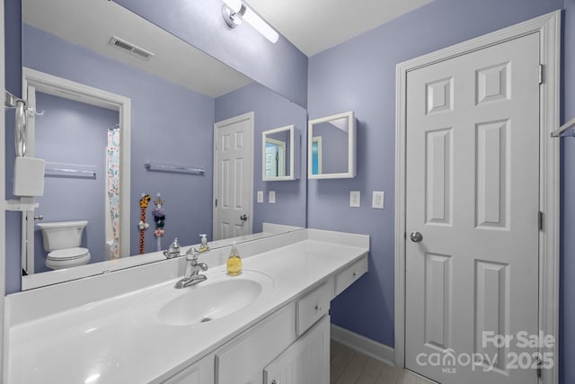 1108 Longwood Ct, Matthews, NC 28104 - bathroom featuring toilet, vanity, baseboards, and a shower with curtain