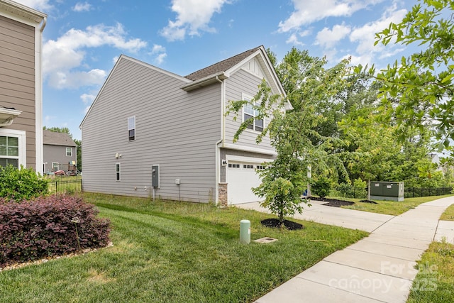 view of property exterior featuring driveway and a garage