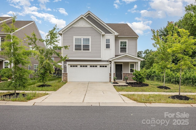 craftsman inspired home featuring fence, stone siding, driveway, and an attached garage