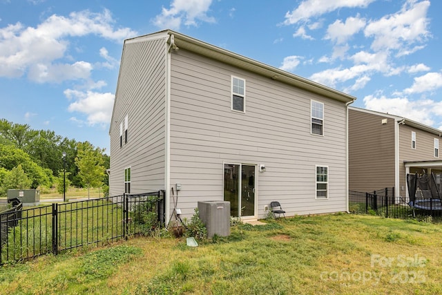 back of house with central AC unit