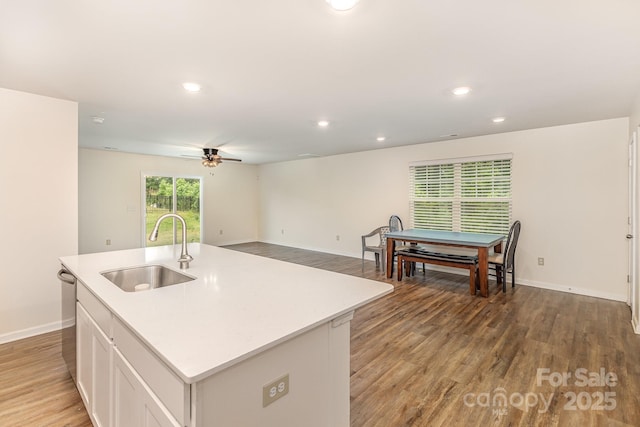 kitchen featuring a sink, a ceiling fan, baseboards, light wood-style flooring, and recessed lighting