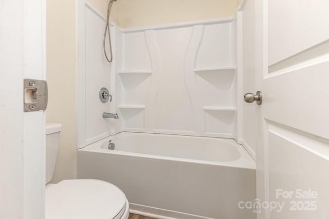 bathroom featuring toilet and shower / bathtub combination