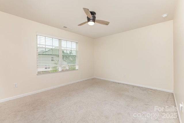 carpeted empty room featuring a ceiling fan and baseboards