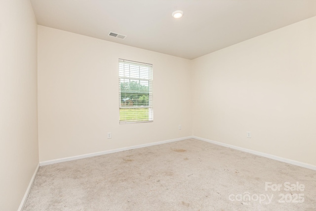 carpeted empty room featuring baseboards and recessed lighting