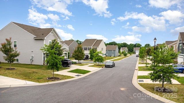 view of asphalt road with a residential view, street lights, sidewalks, and curbs