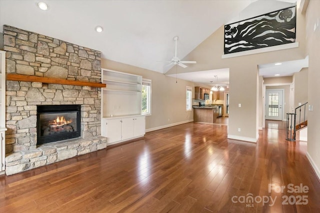 452 Kyfields, Weaverville, NC 28787 - unfurnished living room featuring ceiling fan, a stone fireplace, healthy amount of natural light, wood finished floors, and high vaulted ceiling
