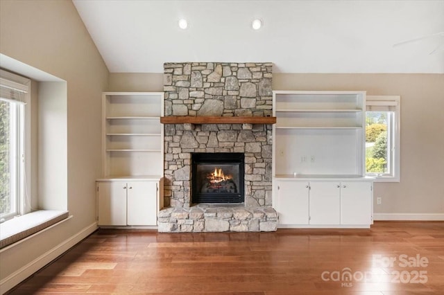 452 Kyfields, Weaverville, NC 28787 - unfurnished living room featuring a fireplace, vaulted ceiling, wood finished floors, and baseboards