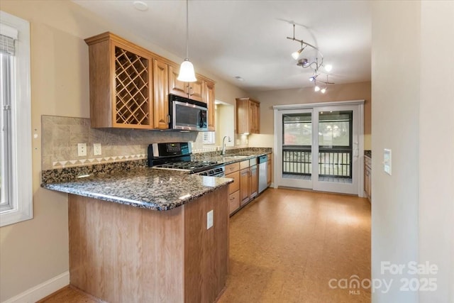 452 Kyfields, Weaverville, NC 28787 - kitchen featuring stainless steel appliances, a sink, a peninsula, tasteful backsplash, and dark stone counters