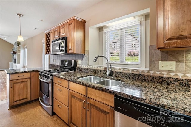 452 Kyfields, Weaverville, NC 28787 - kitchen featuring stainless steel appliances, a sink, a peninsula, brown cabinetry, and dark stone countertops