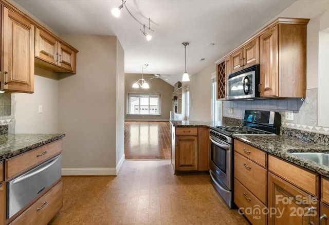 452 Kyfields, Weaverville, NC 28787 - kitchen with appliances with stainless steel finishes, a warming drawer, brown cabinets, lofted ceiling, and tasteful backsplash