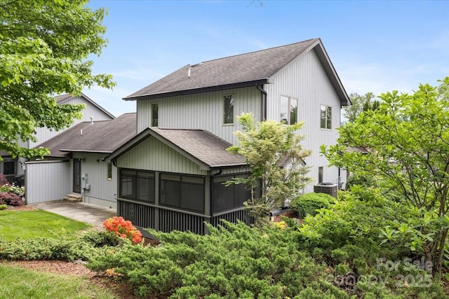 452 Kyfields, Weaverville, NC 28787 - back of house featuring a shingled roof, a sunroom, a patio, and central AC