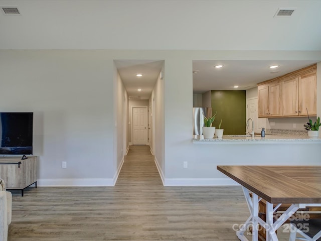 1454 King Rd, York, SC 29745 - kitchen with light brown cabinets, baseboards, light wood-type flooring, recessed lighting, and a sink