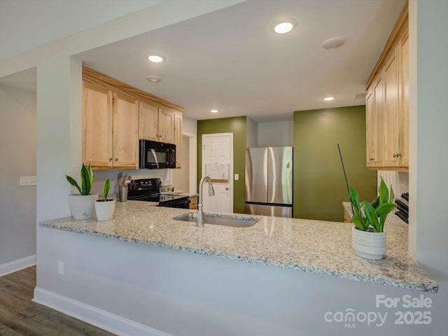 1454 King Rd, York, SC 29745 - kitchen with black appliances, a sink, a peninsula, light brown cabinetry, and baseboards