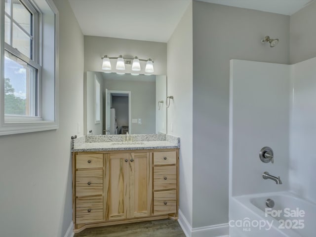 1454 King Rd, York, SC 29745 - bathroom with baseboards, shower / bathtub combination, vanity, and wood finished floors