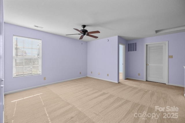 empty room featuring ceiling fan, carpet floors, and baseboards