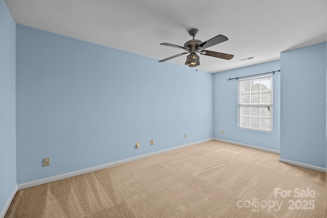 spare room with light carpet, baseboards, and a ceiling fan