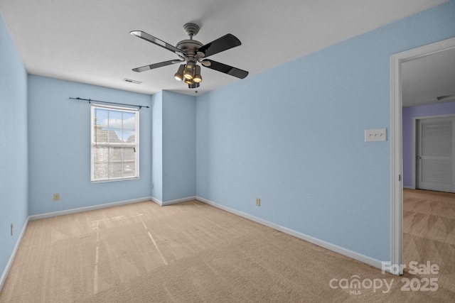 empty room featuring carpet, baseboards, and ceiling fan