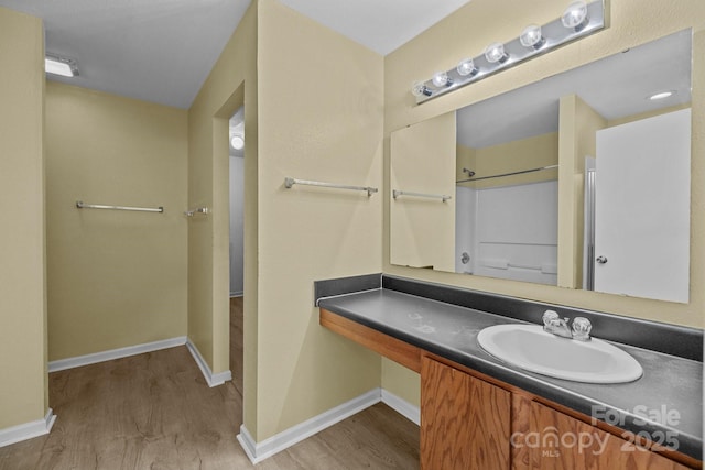 bathroom featuring wood finished floors and baseboards