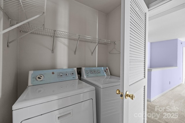 clothes washing area featuring washer and dryer, light colored carpet, and baseboards