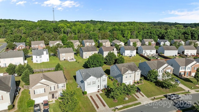 aerial perspective of suburban area featuring a forest