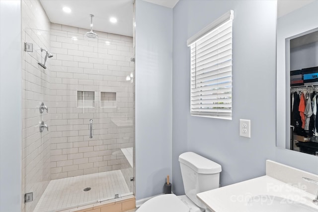 full bathroom with a stall shower, recessed lighting, vanity, and toilet