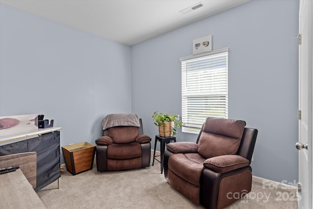living area with light colored carpet and visible vents