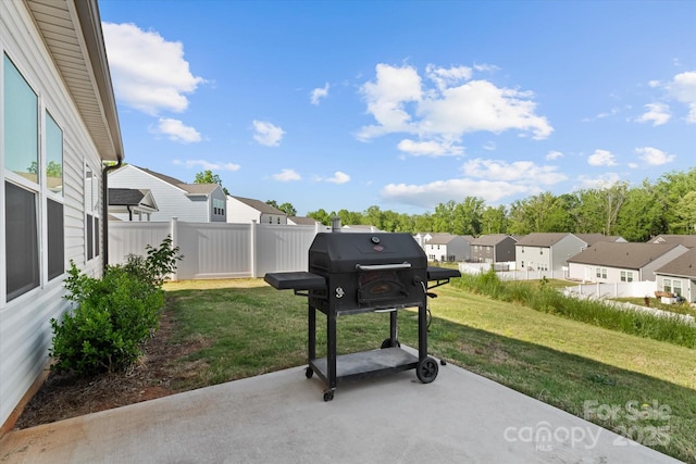 view of patio featuring a residential view and fence
