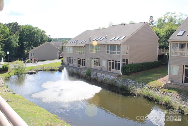 rear view of property with a water view