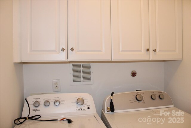 14621 Waterside Dr, Charlotte, NC 28278 - clothes washing area featuring independent washer and dryer, visible vents, and cabinet space