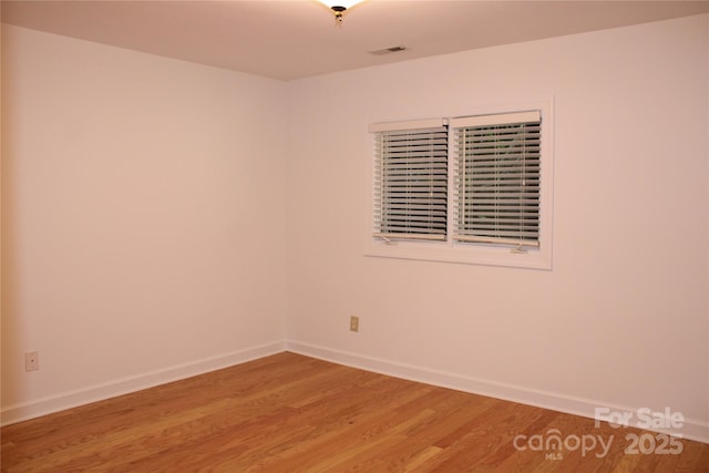 unfurnished room featuring light wood-type flooring and baseboards