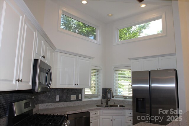 14621 Waterside Dr, Charlotte, NC 28278 - kitchen with white cabinets, appliances with stainless steel finishes, and a sink