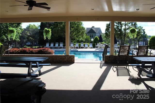 pool with a patio area and ceiling fan