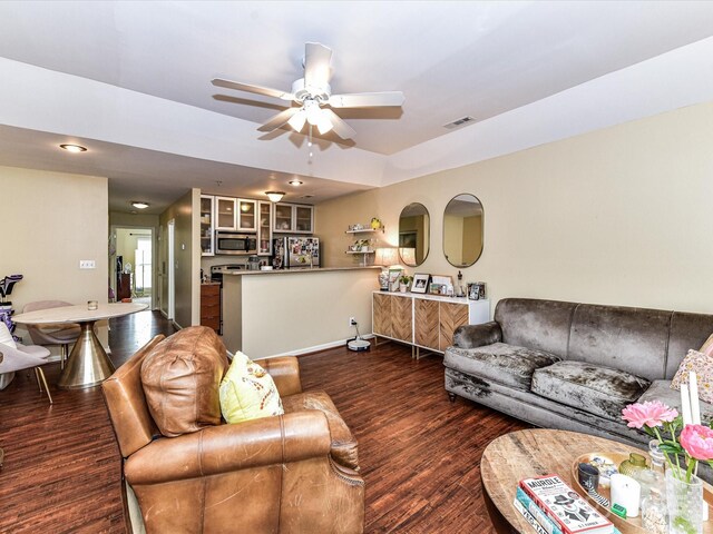 living room featuring a ceiling fan, wood finished floors, and baseboards