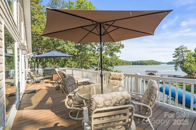 592 Shoreline Rd, New London, NC 28127 - wooden terrace with outdoor dining area and a water view